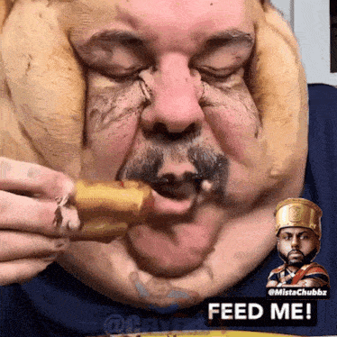 a man with a crown on his head is eating a chicken nugget with the caption feed me