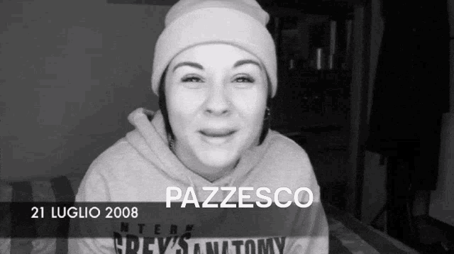 a black and white photo of a woman wearing a beanie and a grey anatomy sweatshirt