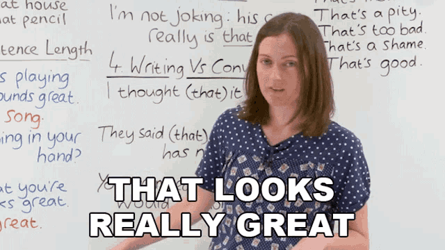 a woman giving a thumbs up in front of a whiteboard that says " that looks really great " on it