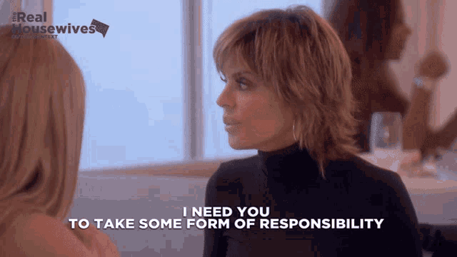 a woman in a black turtleneck is talking to another woman and says " i need you to take some form of responsibility "