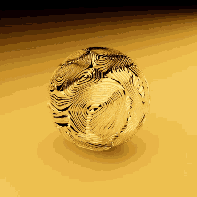 a gold colored sphere with a pattern of lines on it
