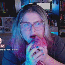 a woman wearing glasses is holding a pink object in her hand