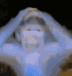 a blurry picture of a person holding their head with their hands
