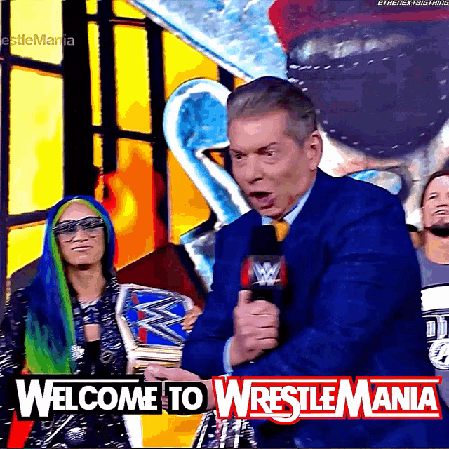 a man speaking into a microphone with the words welcome to wrestlemania