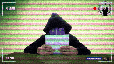 a person holding a piece of paper with a cross on it in front of a green screen that says grupo emojr