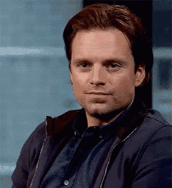a close up of a man 's face with a serious look on his face