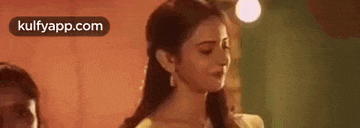 a woman in a yellow dress is standing next to a woman in a yellow dress .