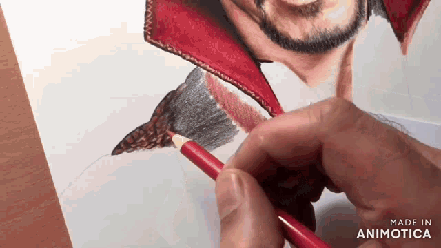 a person is drawing a man with a red pencil on a piece of paper that says made in animatica on the bottom