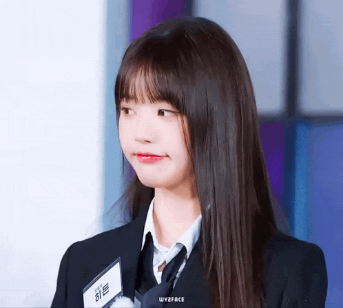 a girl in a suit and tie has a name tag that says wyzface