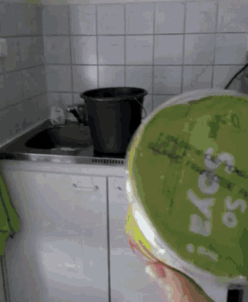 a person holding a green container that says soya on it