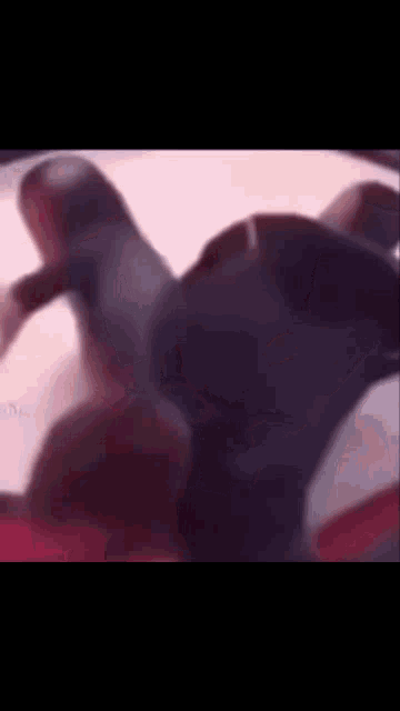 a blurry picture of a person laying on a bed with their legs crossed