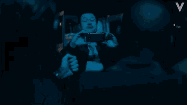 two men are sitting next to each other and one has a watch on