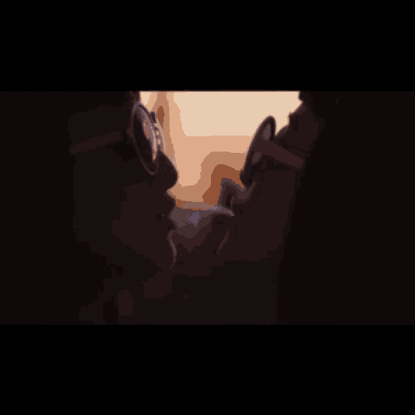 two women wearing sunglasses are kissing in a dark room