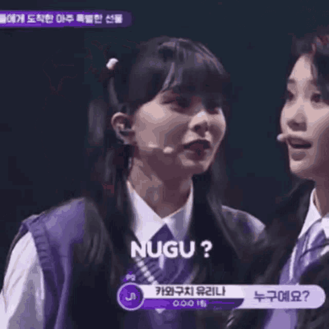 two girls are standing next to each other and one of them is wearing a purple sweater and tie .
