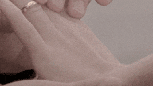 a close up of a person holding another person 's hand