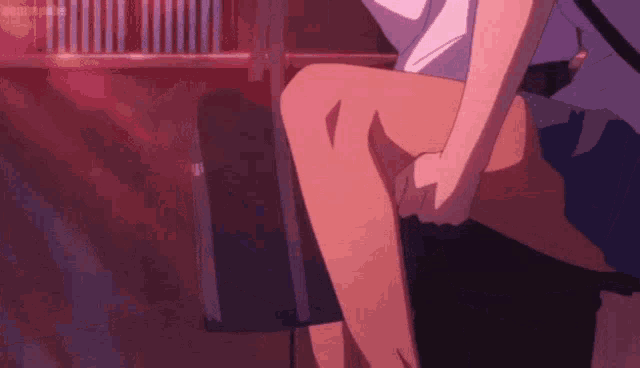 a man and a woman are sitting next to each other and the woman is holding the man 's leg .