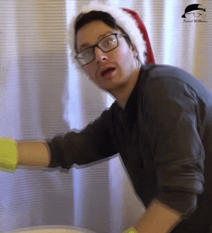 a man wearing a santa hat and glasses is cleaning a shower curtain