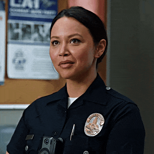 a woman in a police uniform with a badge that says los angeles