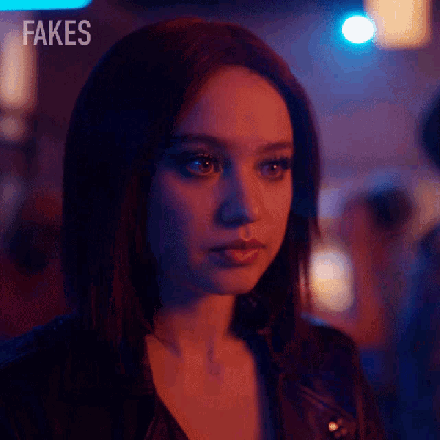 a close up of a woman 's face with fakes written on the bottom right