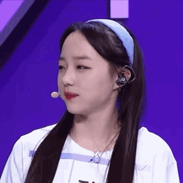 a close up of a girl wearing a headband and headphones