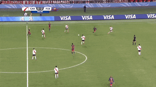 a soccer game is being played on a field that has visa advertisements