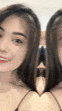 a close up of a woman 's face with a reflection of another woman in her hair