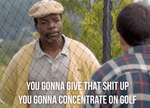 a man in a yellow jacket is talking to another man in a plaid shirt