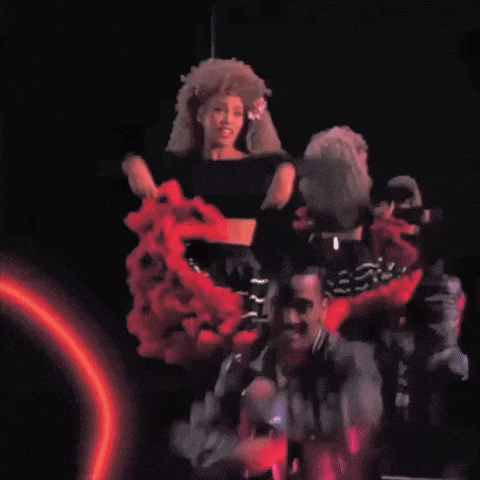 a group of people are dancing in a dark room with red smoke coming out of them
