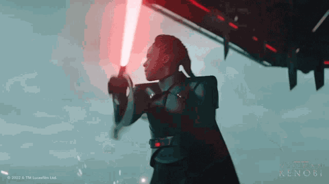 a woman is holding a red lightsaber in front of a star wars logo