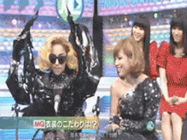 a woman in a sequined dress is holding a green balloon in her hand