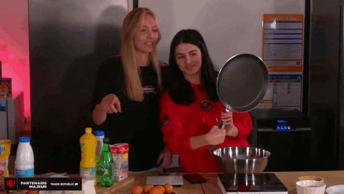 two women cooking in front of a sign that says partenaire