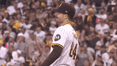 a baseball player with a mustache and the number 84 on his jersey is standing in front of a crowd .