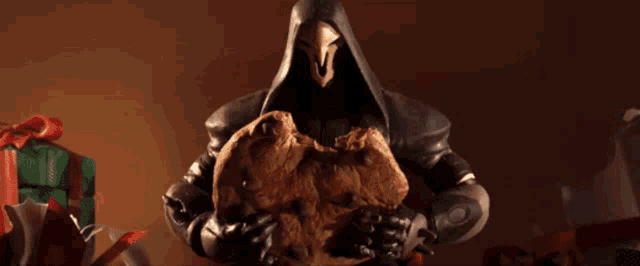 a figurine of reaper holding a cookie in front of gifts