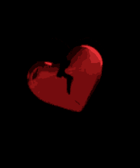 a pixel art of a red heart with a black background