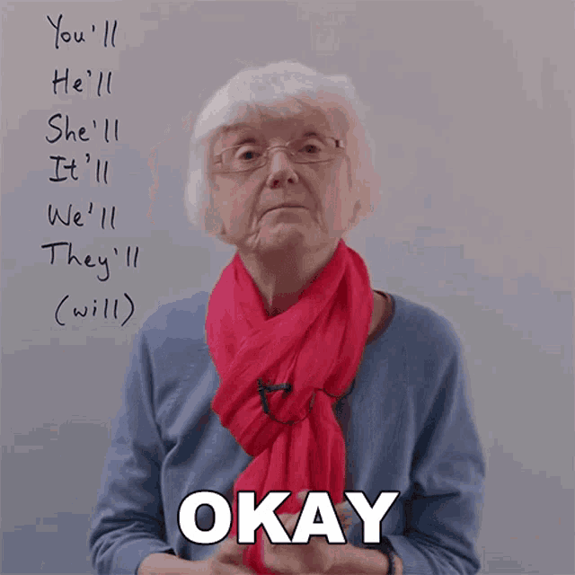 an older woman wearing glasses and a red scarf says " okay "