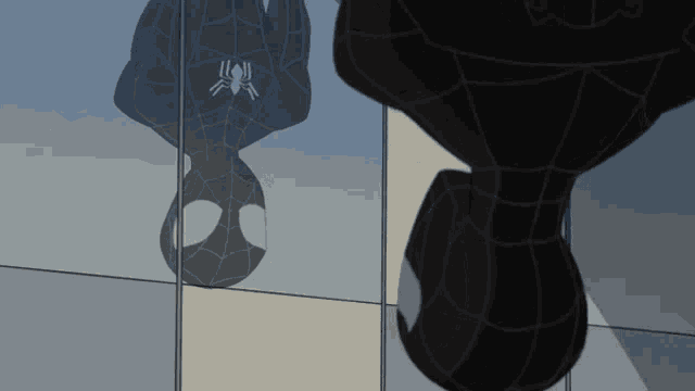 a drawing of a spider man hanging upside down on a wall