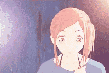 a close up of a girl 's face with a ponytail .