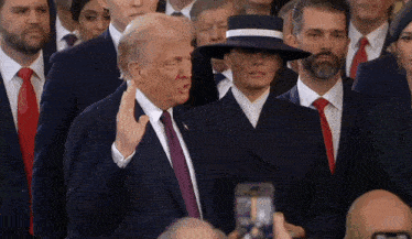 a man in a suit and tie is giving a speech