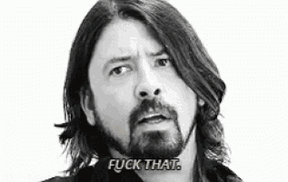 a man with long hair and a beard is saying " fuck that " .