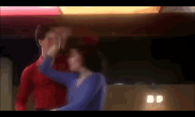 a blurry picture of a man and a woman dancing