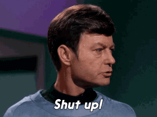 a close up of a man 's face with the words shut up written on it