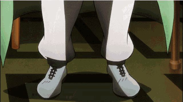 a close up of a person 's feet with white shoes