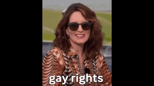 a blurry picture of a person holding a gun with the words `` gay rights '' written on the bottom .
