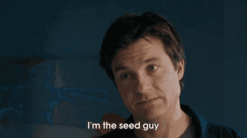 a man says i 'm the seed guy in front of a blue wall
