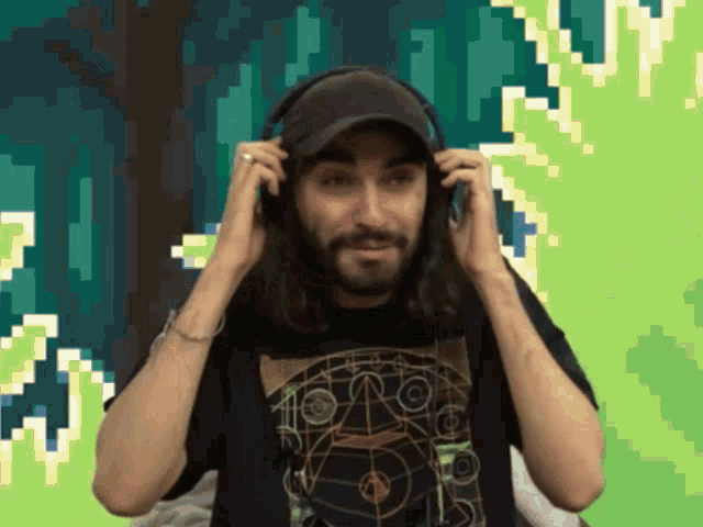a man with long hair and a beard wearing headphones and a black shirt with the number 10 on it