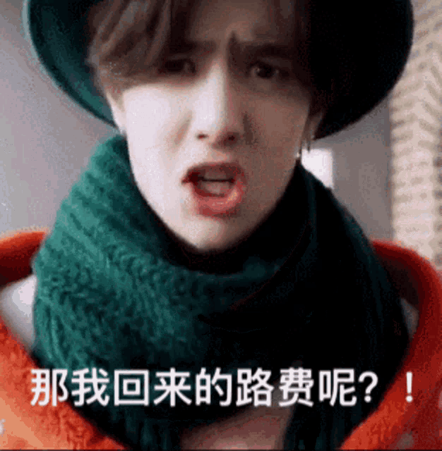 a young man wearing a hat and scarf is making a funny face in a foreign language .