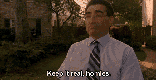 a man in a white shirt and tie says " keep it real homies "