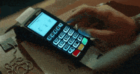 a person is using a credit card machine with the numbers 0-9 on it