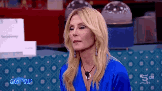 a woman in a blue dress with the hashtag #gfvip on the bottom