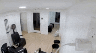 a blurred image of a salon with a woman standing in the middle